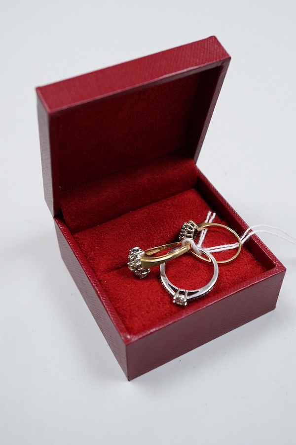 A collection of three rings, comprising: a ring, set with a brilliant-cut diamond weighing approximately 0.20 carats, to shoulders set with smaller brilliant-cut diamonds totalling approximately 0.16 carats, mounted in 9